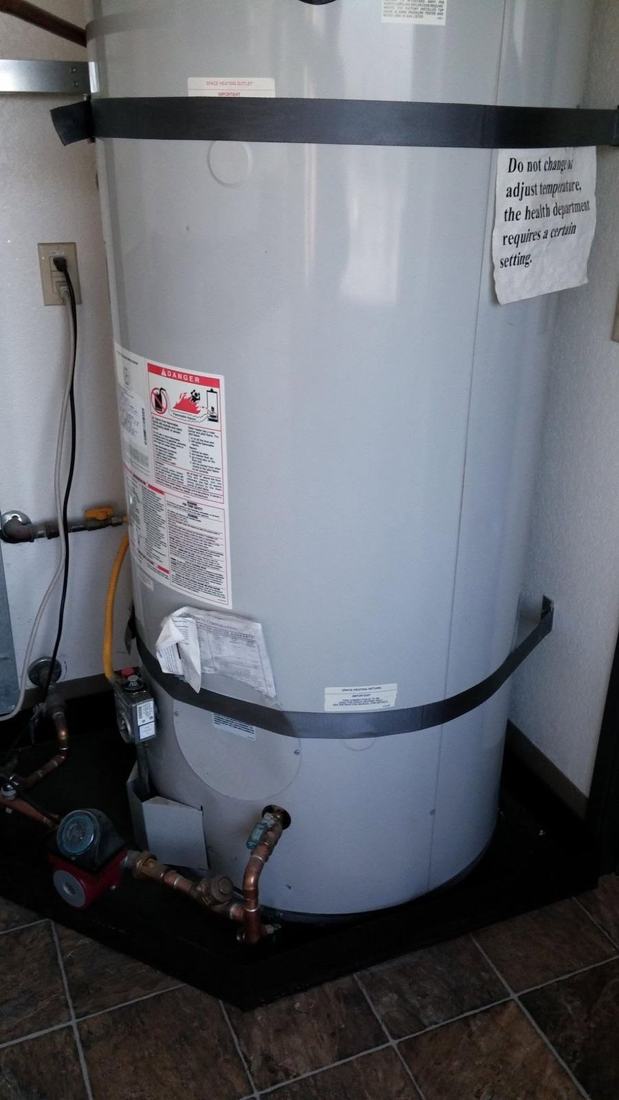 Large gas water heater installed with seismic strapping, copper piping and a recirculation pump