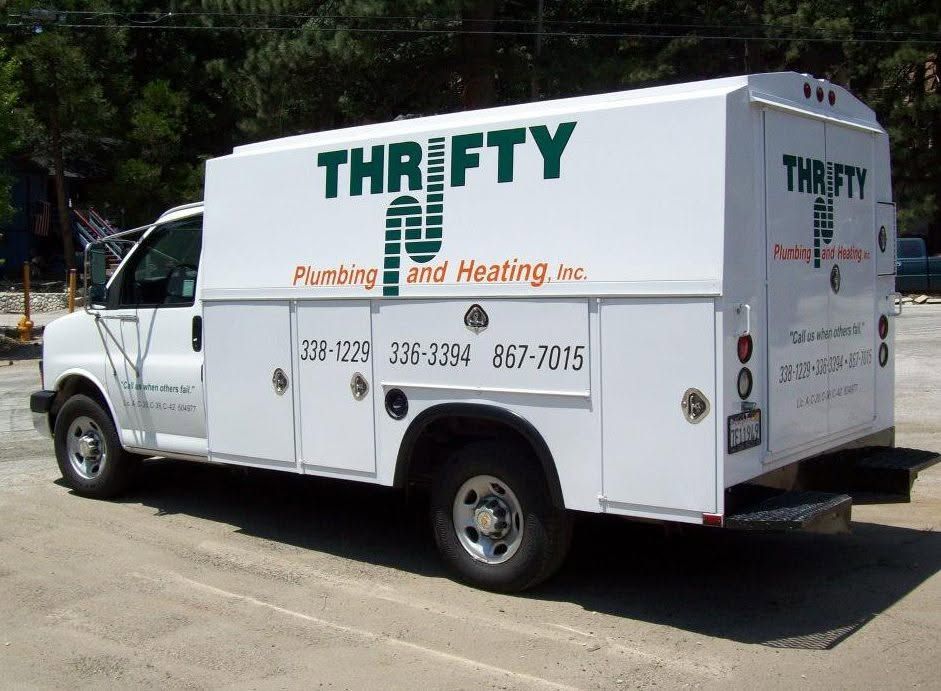 Thrifty Plumbing and Heating service truck with the company logo and its three phone numbers: 338-1229, 336-3394 and 867-7015